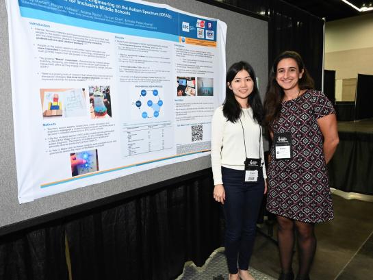 2 female students posing next to poster at annual CEC Convention